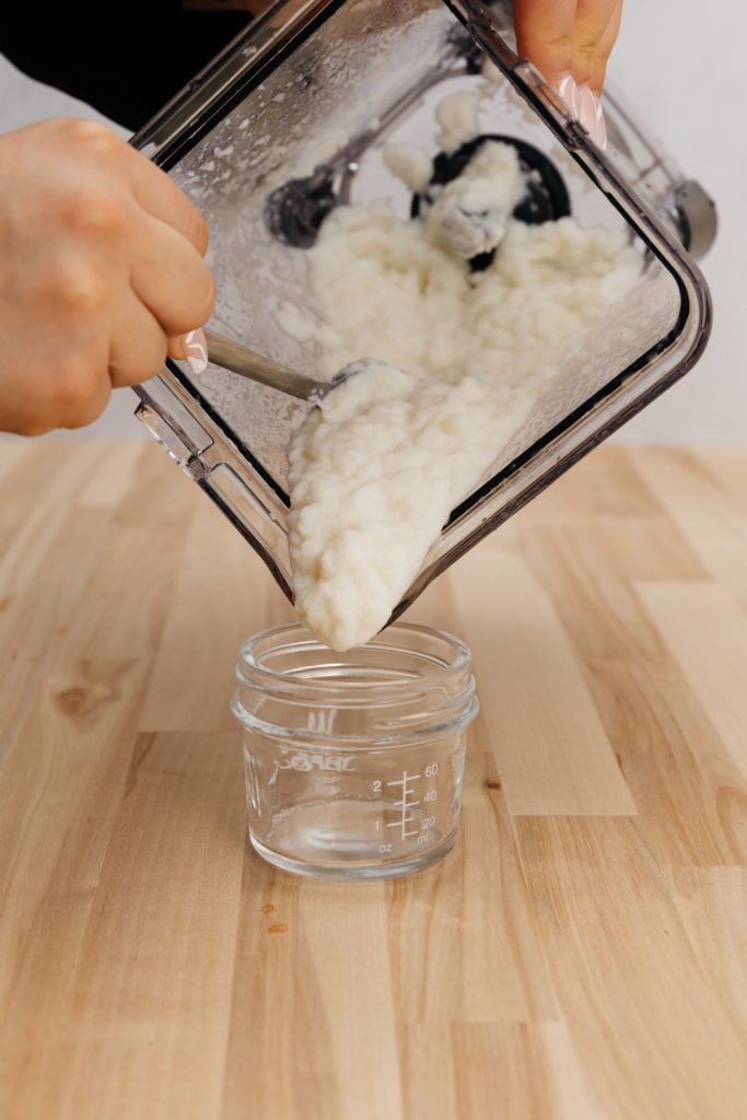 pouring turnips puree into a glass container