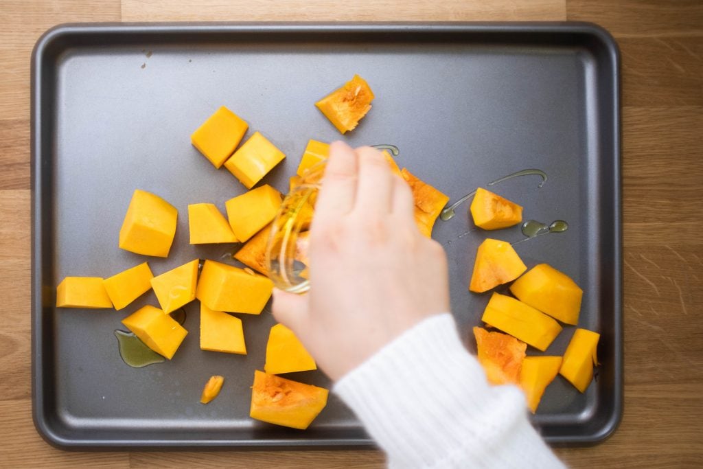 cubed butternut squash with olive oil