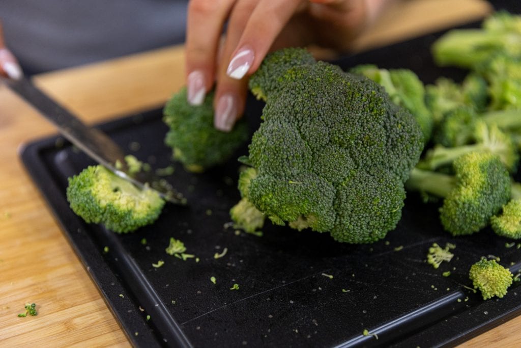 cutting broccoli heads into florets