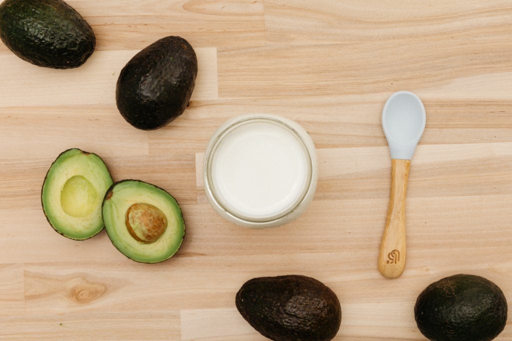 milk, avocados and a baby spoon