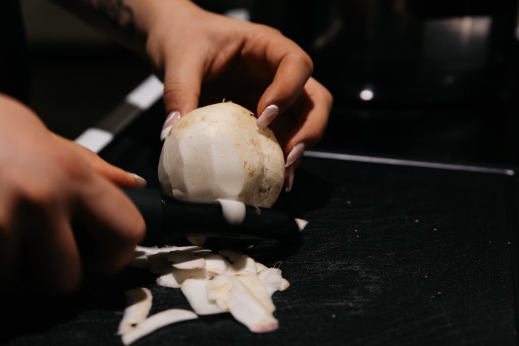 woman peeling turnips for puree