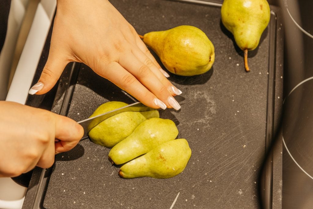 slicing pears on a cutting board